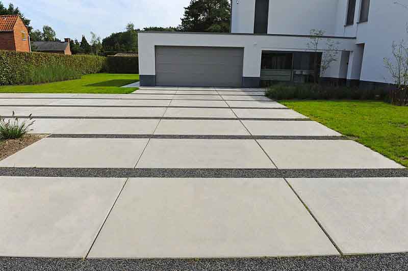 Better concrete. Driveway. Black Concrete on driveway. Driveway Landscaping ideas. Concrete Yard.